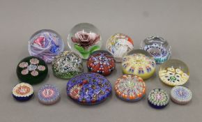 A collection of glass paperweights. The largest 9 cm diameter.