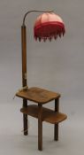 An Art Deco standard lamp/side table. 146 cm high.