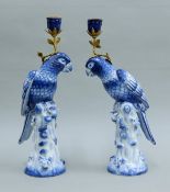 A pair of gilt metal-mounted blue and white parrot-form candlesticks. Each 36 cm high.