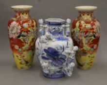 A pair of large Satsuma vases and a Chinese blue and white porcelain vase decorated with boys.