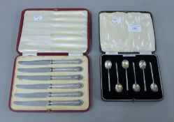 A set of silver coffee spoons in an associated case and a cased set of silver-handled knives.