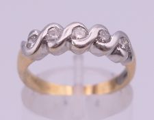 A 14 K gold and five stone diamond ring. Ring size M. 4.1 grammes total weight.
