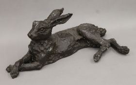 A bronze model of a recumbent hare. 65 cm long.