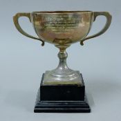 A silver trophy cup on stand with presentation inscription. 21 cm high overall. 440.6 grammes.