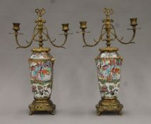 A pair of 19th century ormolu-mounted Canton candelabra. Each 40.5 cm high.