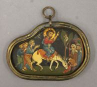 An unusual black stone pebble painted with Christ's entry into Jerusalem,