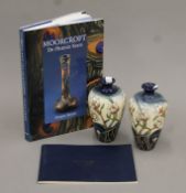 Two boxed Moorcroft vases and' Moorcroft: The Phoenix Years' by Fraser Street. The former each 15.