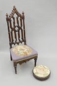 A Victorian Gothic Revival walnut side chair and a Victorian tapestry-topped walnut footstool.