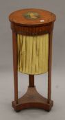 A Victorian painted satinwood work table. 76 cm high.