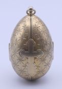 A Russian silver gilt egg enclosing a religious icon (St Nicholas). 7.5 cm high. 97.