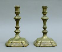 A pair of early 750 silver candlesticks. Each 20 cm high.