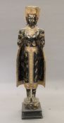 A large Eastern carved and painted wooden model of Buddha set with various glass beading.