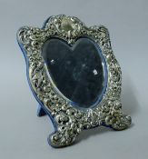 A sterling silver heart-shaped strut mirror. 17.5 cm high.