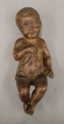 A wooden carving of a young boy. 33 cm high.