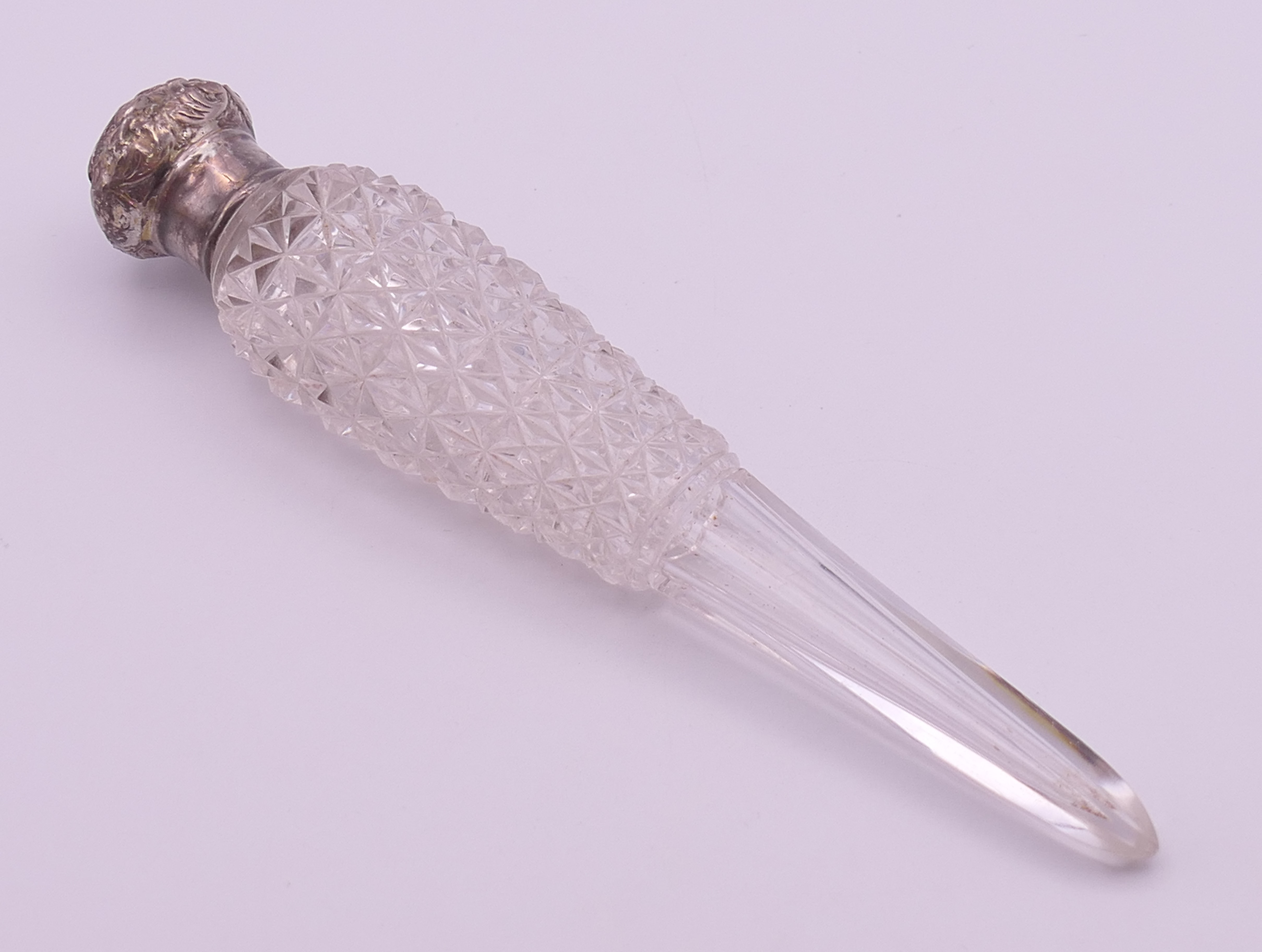 A silver-topped cut glass scent bottle. 18 cm high.