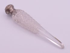 A silver-topped cut glass scent bottle. 18 cm high.