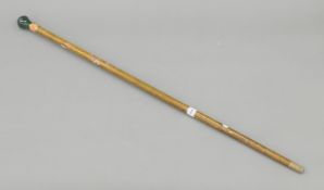 A walking stick with enamel and jade handle. 95 cm high.