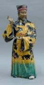 A Chinese pottery figure of a deity. 42.5 cm high.