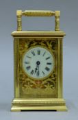 A brass carriage clock with fretwork dial. 15 cm high overall.