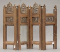 A miniature Eastern carved wooden folding screen. 47 cm high.