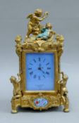 A mantle clock set with putto and a cherub. 30 cm high.