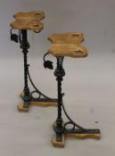 A pair of wrought iron and oak stands. Each 74 cm high.