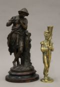 A bronzed model of a man playing a flute and a brass soldier. The former 39 cm high.