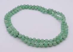 A string of jade beads. Approximately 126 cm long.