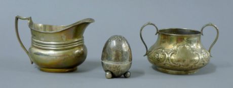 A silver sugar bowl, a silver cream jug and a silver castor. The former 13 cm wide. 355 grammes.