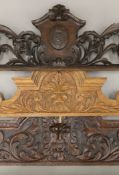 Three carved oak crests. The largest 173 cm long.