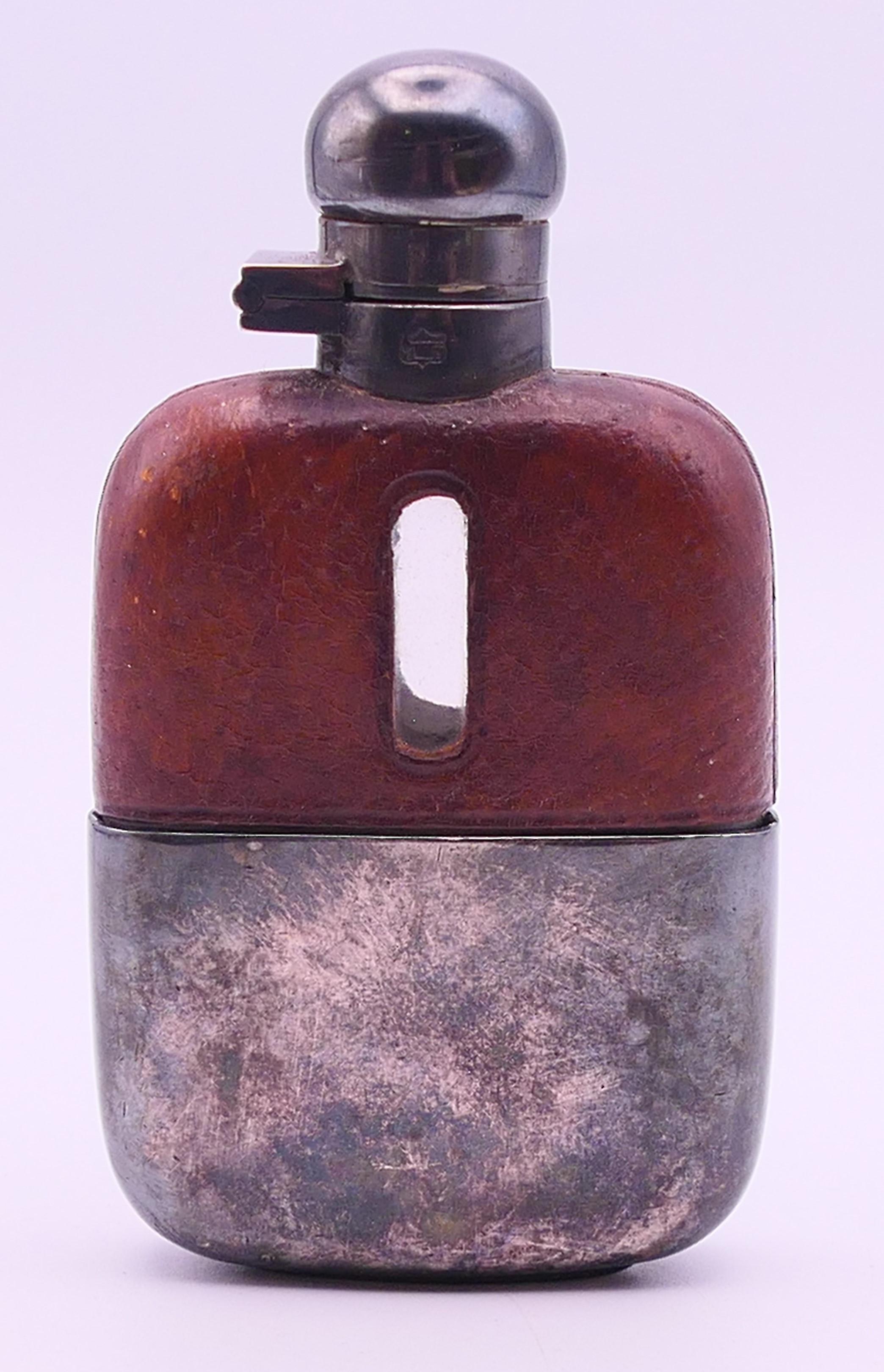 A James Dixon & Son small leather-clad silver plate mounted hip flask. 10.5 cm high.