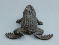 A bronze toad. 16 cm wide.
