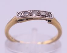 An 18 ct gold five-stone diamond ring. Ring size K. 1.8 grammes total weight.