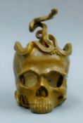 A bronze skull and snake vase. 18.5 cm high.