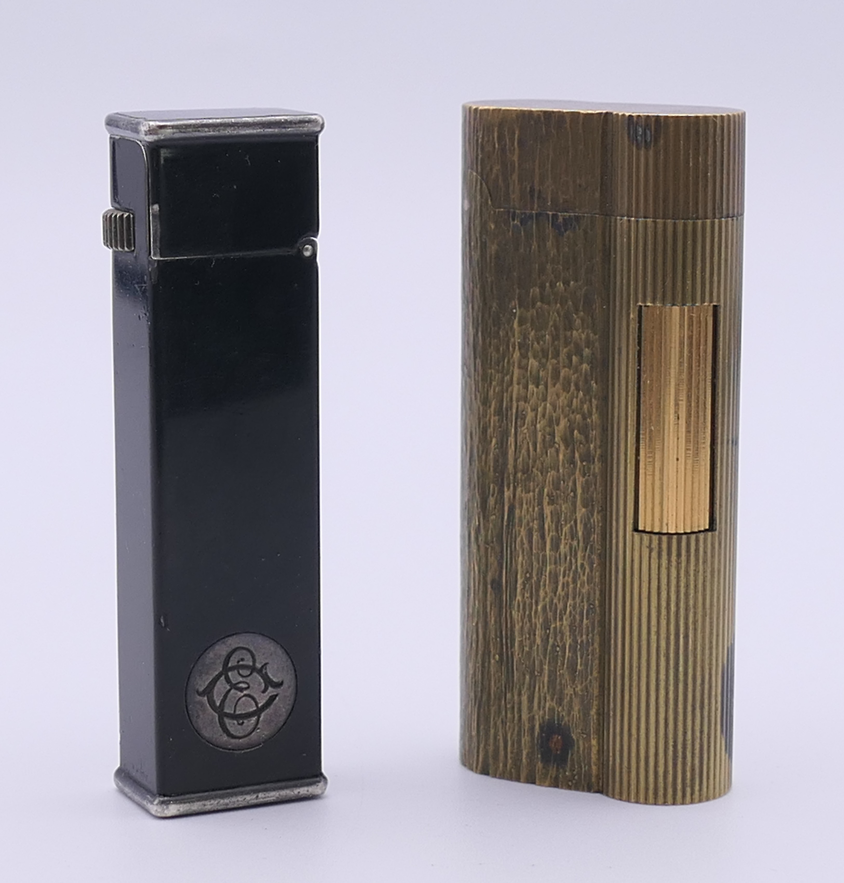 A Dunhill Cartier lighter and a Dunhill lighter. Each 6.5 cm high.