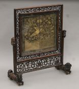 A 19th century Chinese carved wooden table screen with inset tapestry panel. 57 cm high.