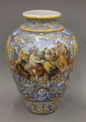 A Ruiz de Luna Talavera ceramic vase decorated with a vignette of Bacchic figures. 60 cm high.