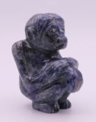A lapis lazuli ape with inset gold and emerald eyes. 8 cm high.