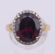 A 9 ct gold, diamond and garnet ring. Ring size Q. 4 grammes total weight.