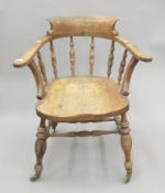 A 19th century elm-seated smoker's bow armchair. 71 cm wide.