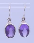 A pair of silver and amethyst earrings. Setting 1.5 cm high.