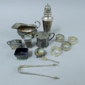 A quantity of silver items, including a sugar caster, a sauce boat, cruets, napkin rings, etc.
