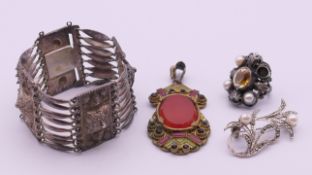 A silver ring, a brooch, a pendant and a white metal bracelet. Bracelet 17.5 cm long, 3.5 cm high.