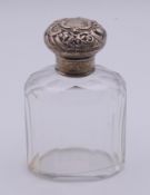 A silver-topped cut glass scent bottle. 10.5 cm high.
