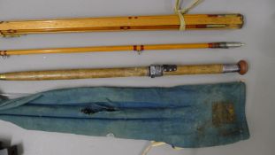 A Hardy Bros The Pennell steel centred salmon fly rod with multi tipped sections on a rod former.