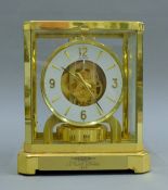 A Le Coultre atmos clock. 24 cm high.