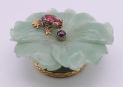 A silver, enamel and diamond frog on jade lotus leaf, bearing Russian marks. 8 cm diameter.