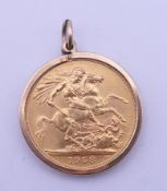A 1958 Elizabeth II gold sovereign with 9 ct gold mount. 2.4 cm diameter. 9.3 grammes total weight.