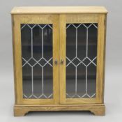 A glazed oak bookcase. 83 cm wide x 98 cm high.