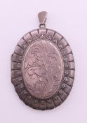 A large silver locket. 5.5 cm high excluding suspension loop.